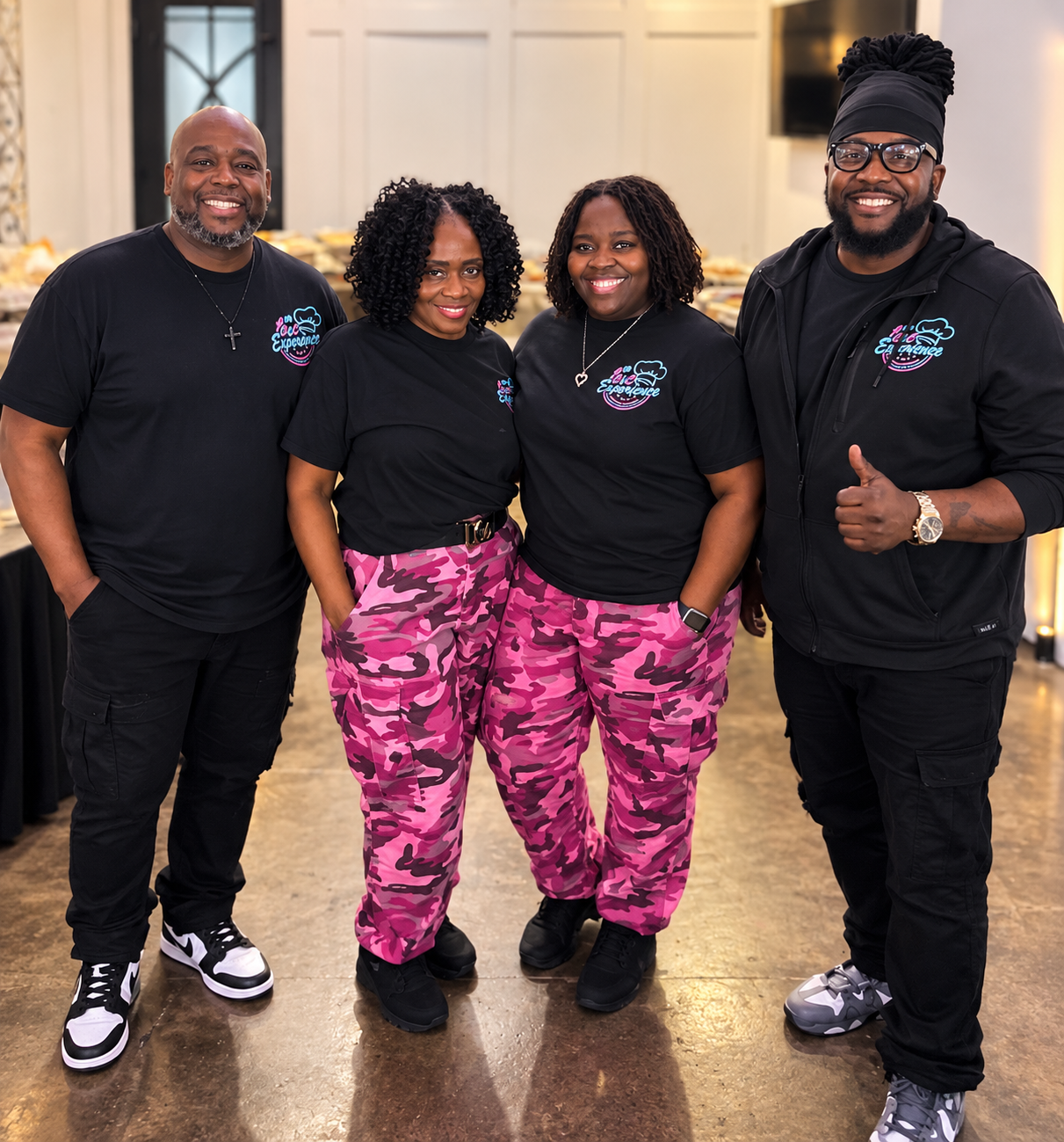 Camil, Brandon, Thelma and JT of the C&C Experience family in branded black shirts and pink camo pants
